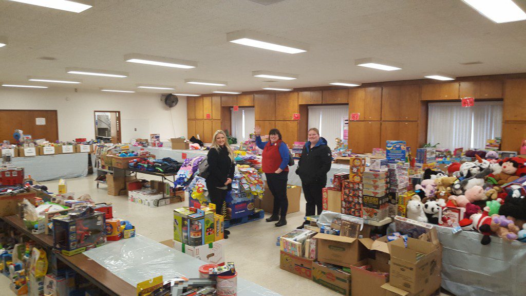 A group of people standing around some boxes