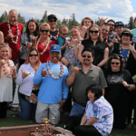 A group of people standing in front of some fire pits.