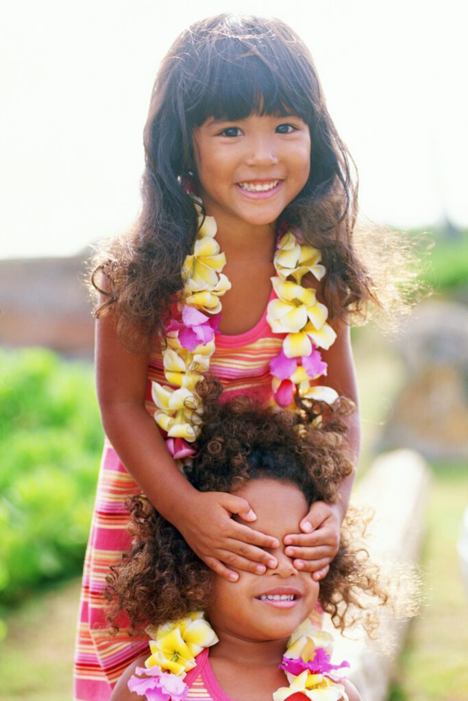 A young girl holding onto her curly hair