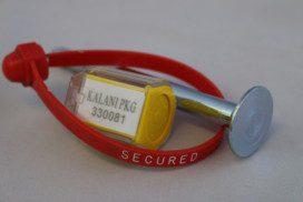 Security seal with yellow tag and metal component.